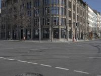 two people in red jackets are on a skateboard and crossing street at an intersection