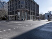 the street in a downtown is empty from cars going by on it and pedestrians walking by