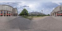 several building along a city street in the day time 360 - view technique, showing the intersection with the circle of building