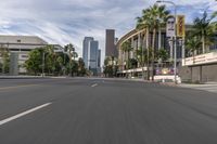 a photo of downtown buildings on a sunny day in las vegas with the cars moving through