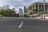 a photo of downtown buildings on a sunny day in las vegas with the cars moving through