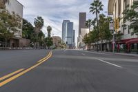 a photo of downtown buildings on a sunny day in las vegas with the cars moving through