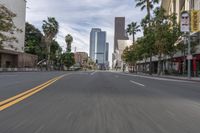 a photo of downtown buildings on a sunny day in las vegas with the cars moving through