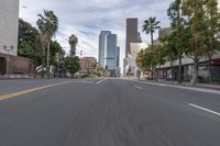 a photo of downtown buildings on a sunny day in las vegas with the cars moving through