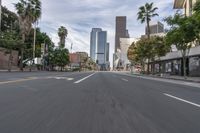 a photo of downtown buildings on a sunny day in las vegas with the cars moving through