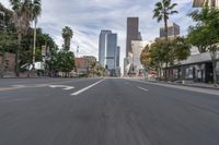 a photo of downtown buildings on a sunny day in las vegas with the cars moving through