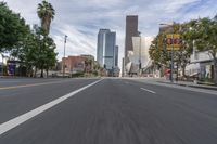 a photo of downtown buildings on a sunny day in las vegas with the cars moving through