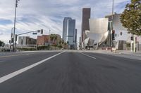 a photo of downtown buildings on a sunny day in las vegas with the cars moving through