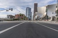 a photo of downtown buildings on a sunny day in las vegas with the cars moving through