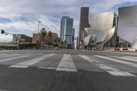 a photo of downtown buildings on a sunny day in las vegas with the cars moving through