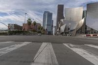 a photo of downtown buildings on a sunny day in las vegas with the cars moving through