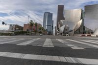 a photo of downtown buildings on a sunny day in las vegas with the cars moving through