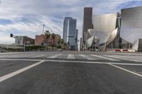 a photo of downtown buildings on a sunny day in las vegas with the cars moving through