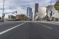 a photo of downtown buildings on a sunny day in las vegas with the cars moving through