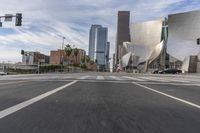 a photo of downtown buildings on a sunny day in las vegas with the cars moving through