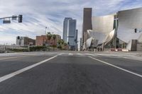 a photo of downtown buildings on a sunny day in las vegas with the cars moving through