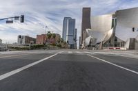 a photo of downtown buildings on a sunny day in las vegas with the cars moving through