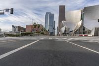 a photo of downtown buildings on a sunny day in las vegas with the cars moving through