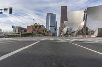 a photo of downtown buildings on a sunny day in las vegas with the cars moving through