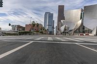 a photo of downtown buildings on a sunny day in las vegas with the cars moving through