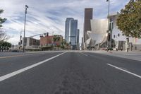 a photo of downtown buildings on a sunny day in las vegas with the cars moving through