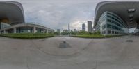 an image of a panorama shot of buildings and landscaping in the distance and with the building behind the photograph