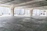 an empty parking garage with large windows and no floor to walk around the room, including a fire hydrant