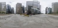 a street view with many tall buildings in the background and a skateboarder on one of them