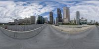 this is a panorama of an urban area with people skateboarding or skating in the park