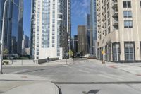 an empty street with some building next to it and traffic light on the right side