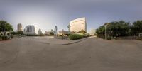 the view from outside of a spherical shot shows a building, and a circular driveway