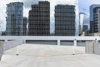 a large grey building with many skyscrapers in the background with no people in it