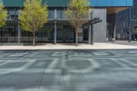 a fire hydrant in front of an office building with glass doors and windows on a sunny day