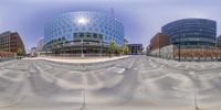 three buildings and one blue building seen from inside of a fisheye lens view mirror