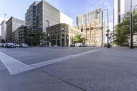 a stop sign next to a crosswalk in front of some tall buildings in a city