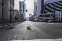 a street with no cars on it in front of skyscrapers and a crosswalk