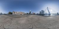 a panoramic photo of downtown buildings from an empty street intersection with the river behind