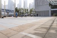 a person is riding a skateboard on a sidewalk in a city area with buildings