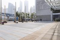 a person is riding a skateboard on a sidewalk in a city area with buildings