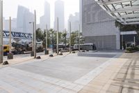 a person is riding a skateboard on a sidewalk in a city area with buildings