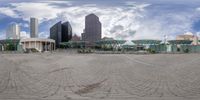 a city in the distance, with buildings around it and a circular photograph of a plaza