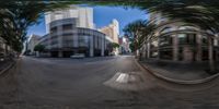 two cars parked on a city street through the panoramic lens of a picture