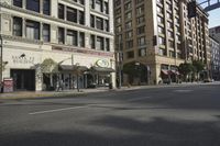 a large brown building with many windows is seen in this photo alone from the intersection