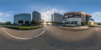 a wide angle image showing a building complex with an empty road in front of it