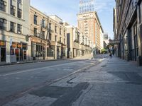 an empty street and buildings on both sides of the road are a few different stories