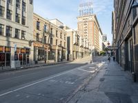 an empty street and buildings on both sides of the road are a few different stories