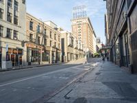 an empty street and buildings on both sides of the road are a few different stories