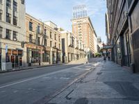 an empty street and buildings on both sides of the road are a few different stories