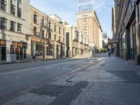 an empty street and buildings on both sides of the road are a few different stories