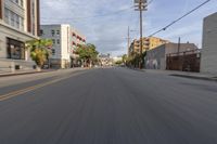 the street is empty as the car rides by on it's turnaround lane